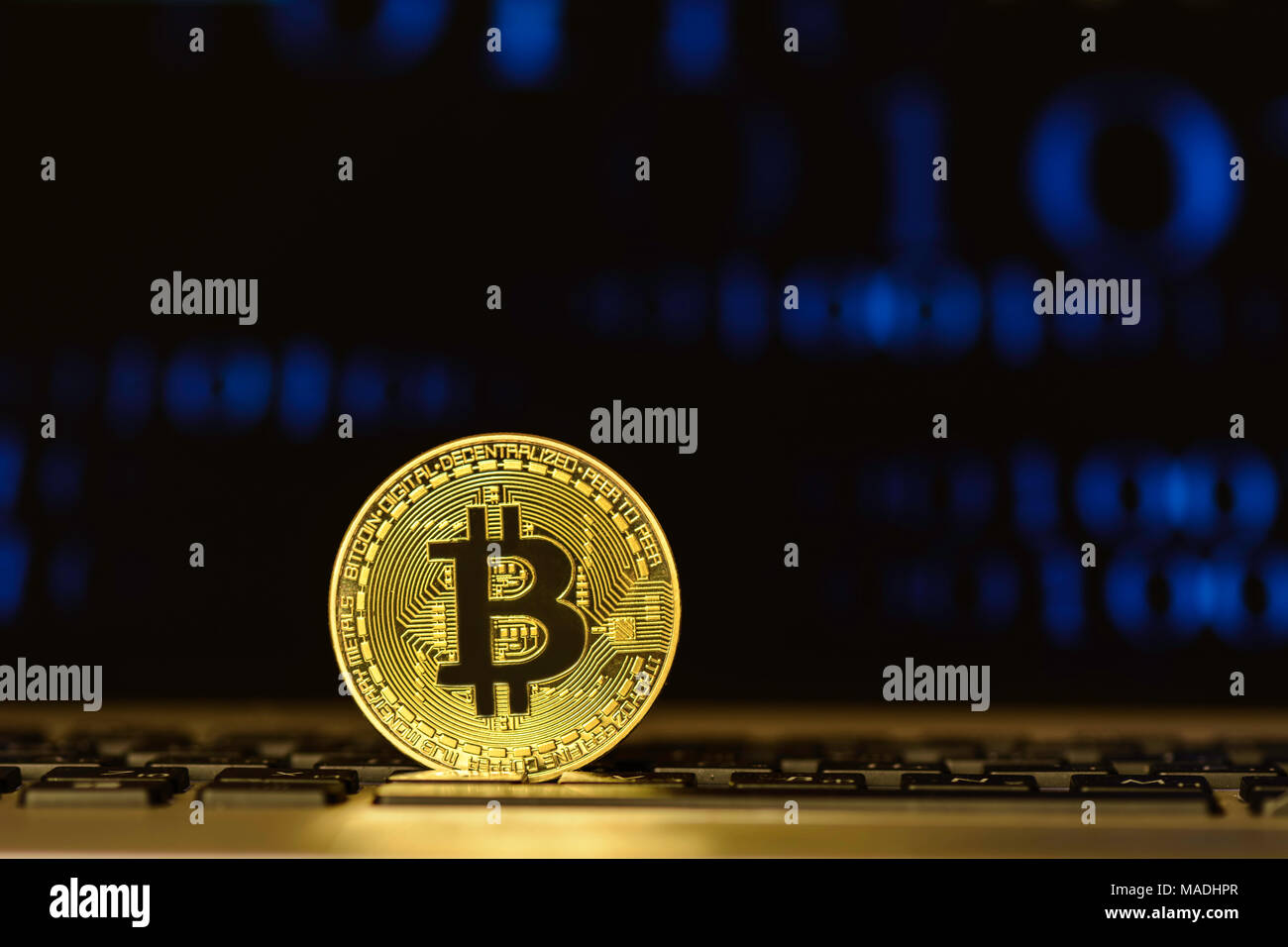 Bitcoin on keyboard against background with blurry graph Stock Photo ...