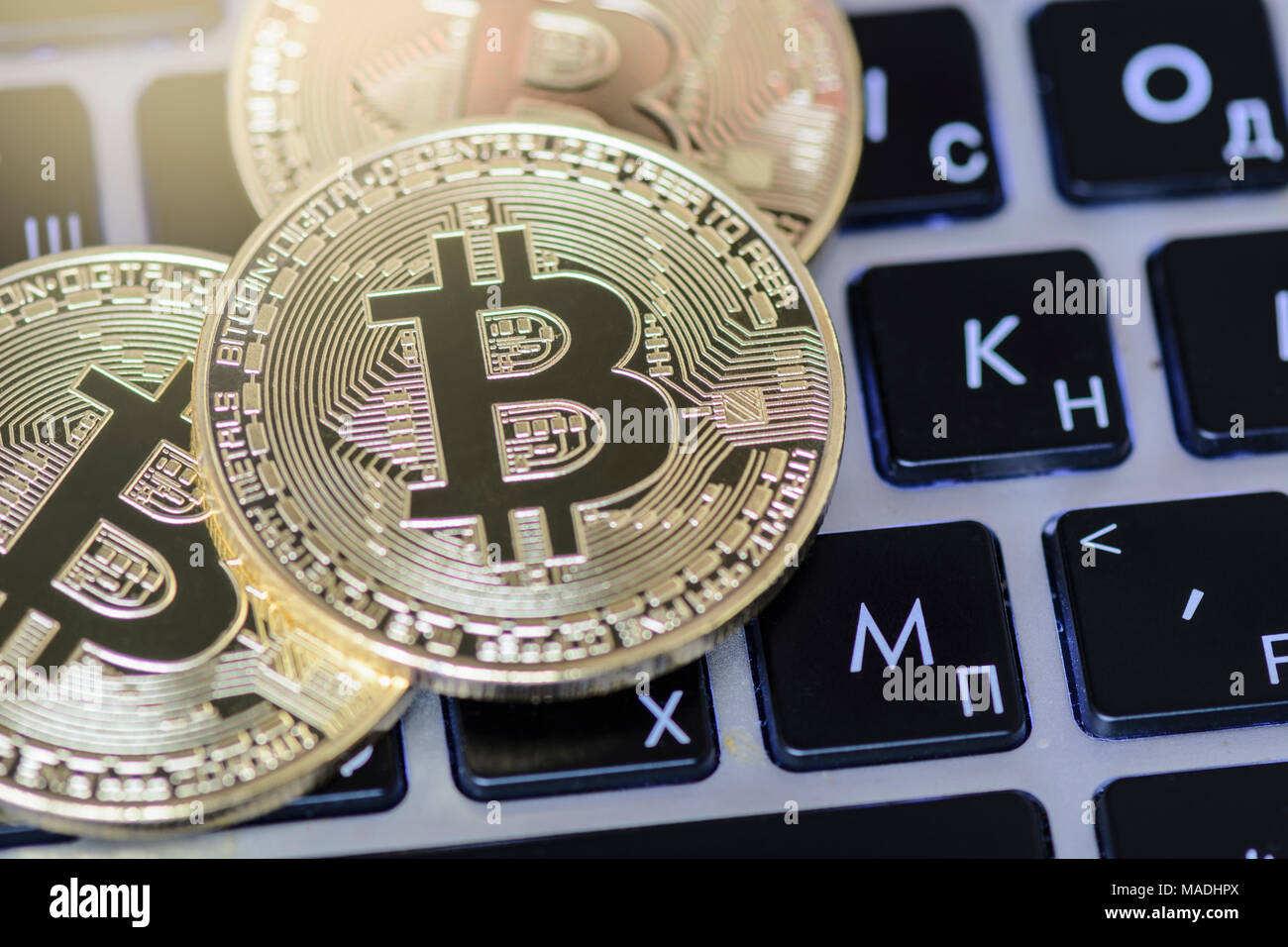 Bitcoin on keyboard against background with blurry graph Stock Photo ...