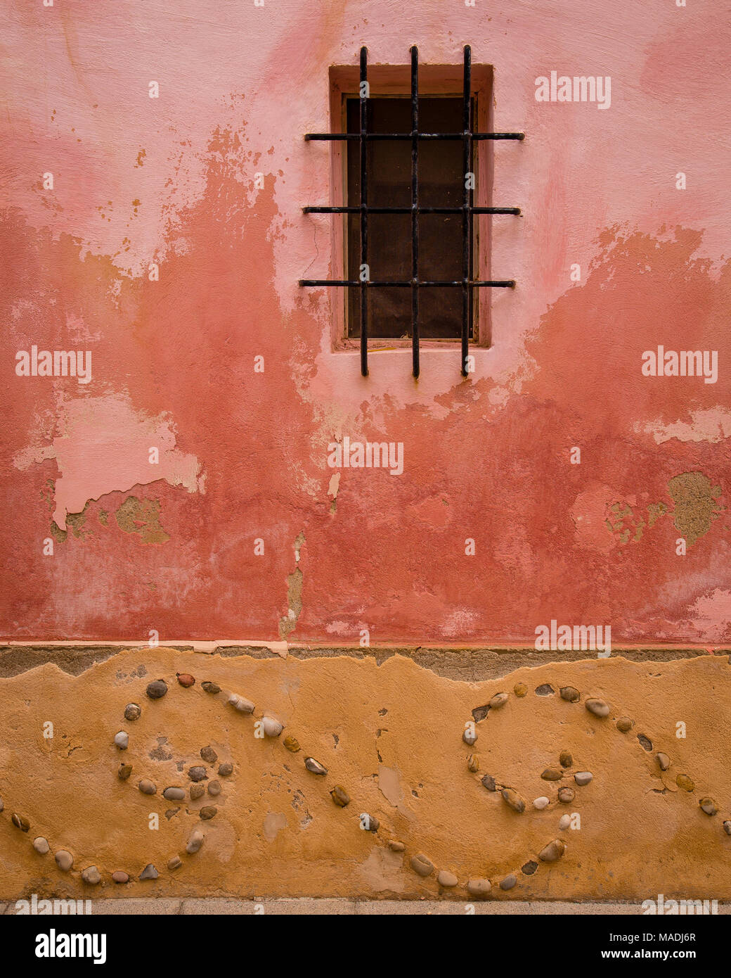 Window and wall with stone patterns and flaking paint, Sant Elm, Mallorca Stock Photo