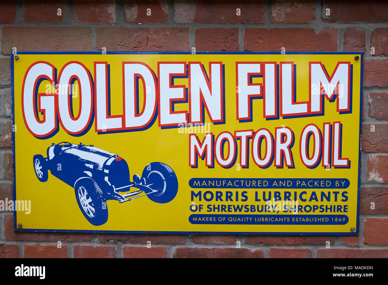 Enamel sign for Golden Film motor oil. North Norfolk Railway, Holt, Norfolk, England. Stock Photo