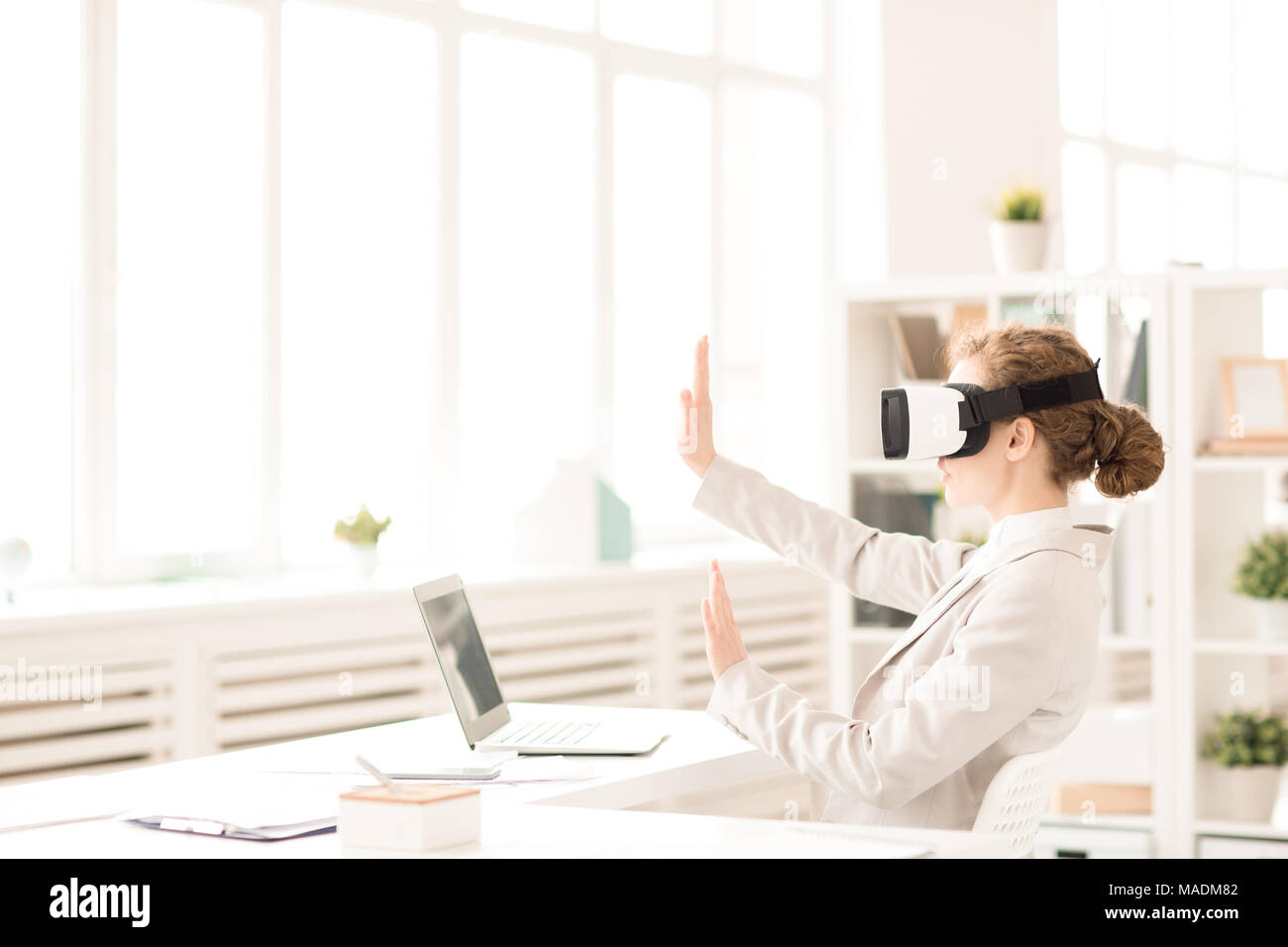 Businesswoman gesturing while using virtual reality simulator Stock Photo