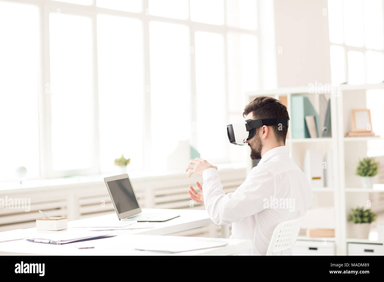 Businessman using virtual reality device in the office Stock Photo