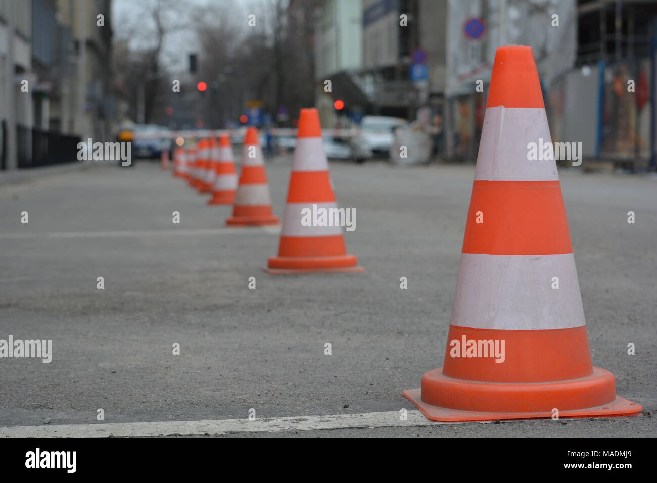 Row of white and orange traffic cones, parking lane restricted Stock Photo