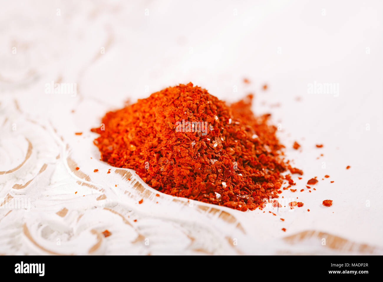 Aleppo Pepper mild chilli flakes in small bowl Stock Photo