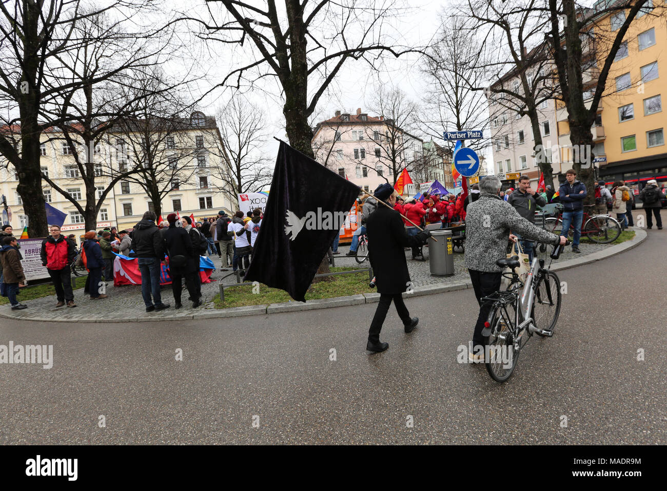 Munich, Germany. 31st Mar, 2018. A man wearing black clothes with a black flag with a white pigeon. Some thousand joined the Ostermarsch (easter march) for peace and disarmament. The Ostermarsch is a traditional peace demonstration, which is held yearly in hundreds of German towns. Credit: Alexander Pohl/Pacific Press/Alamy Live News Credit: PACIFIC PRESS/Alamy Live News Stock Photo