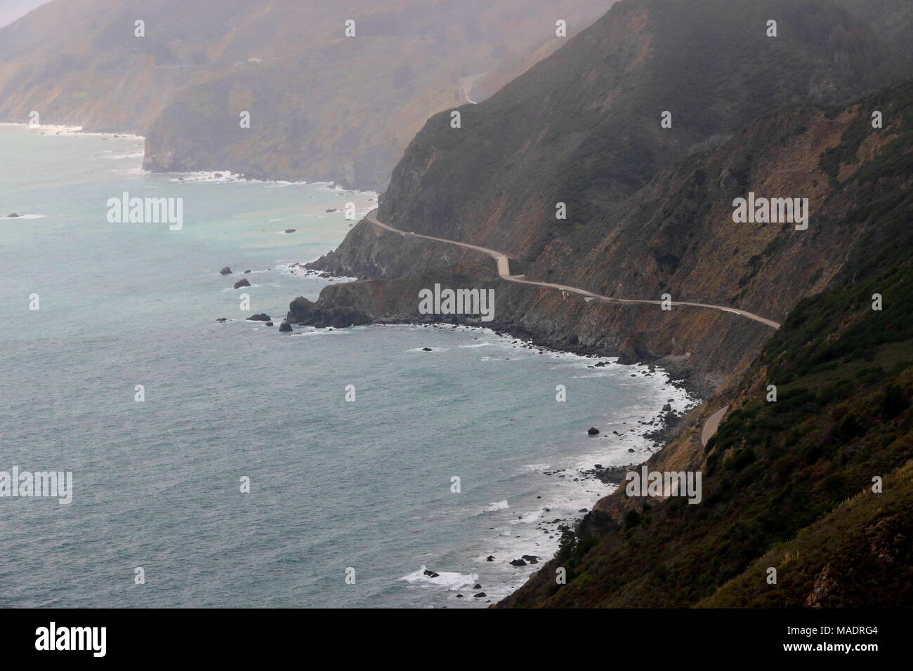 Highway One curves along the dramatic coastline of Big Sur, California ...