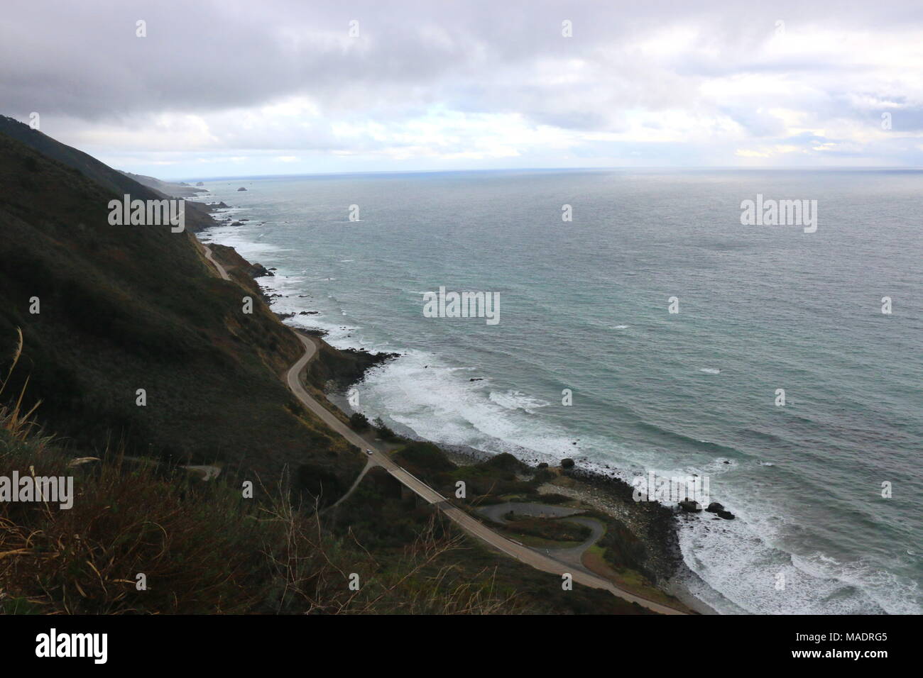 Highway One curves along the dramatic coastline of Big Sur, California ...
