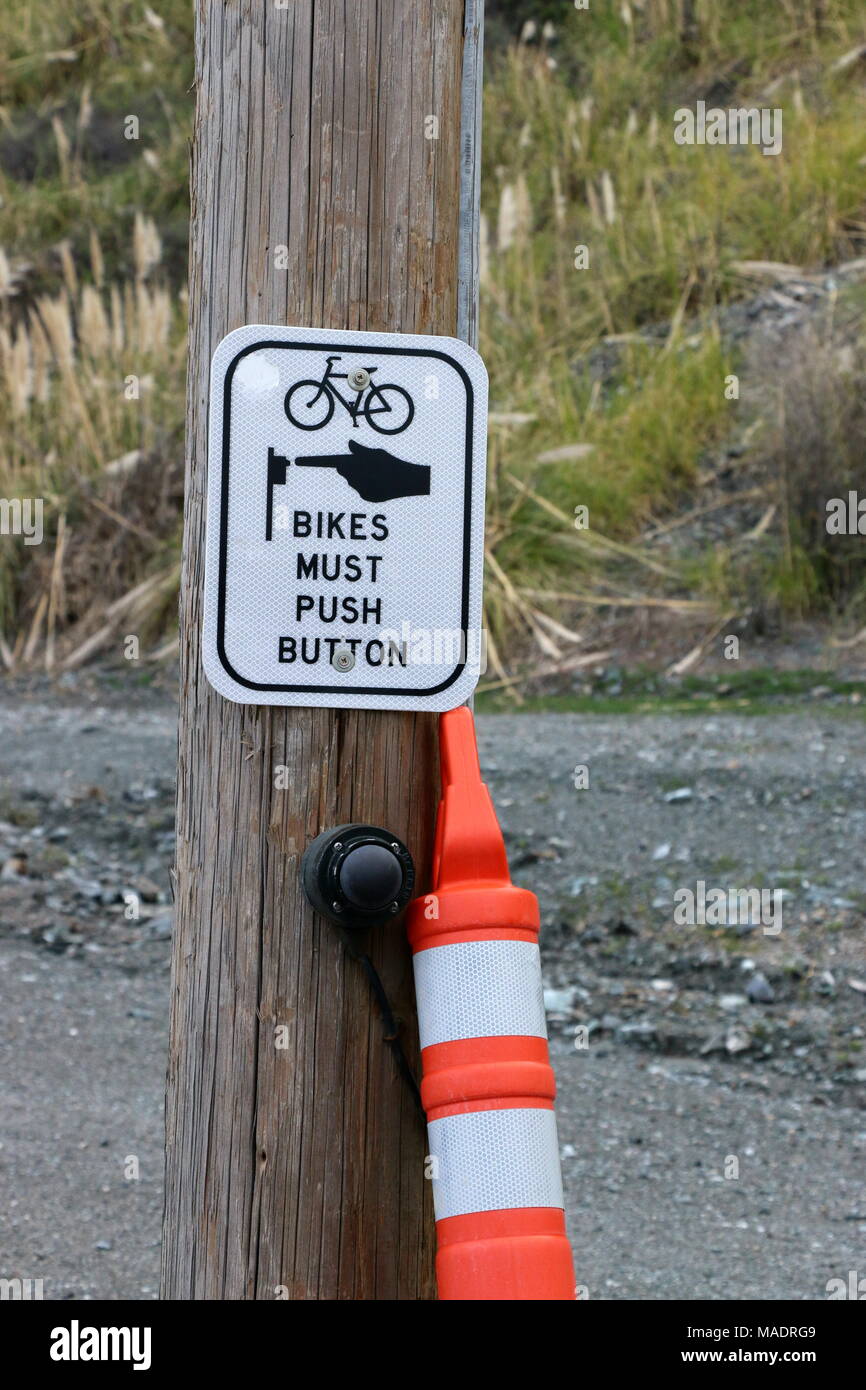 Push button road crossing sign for cyclists. Stock Photo