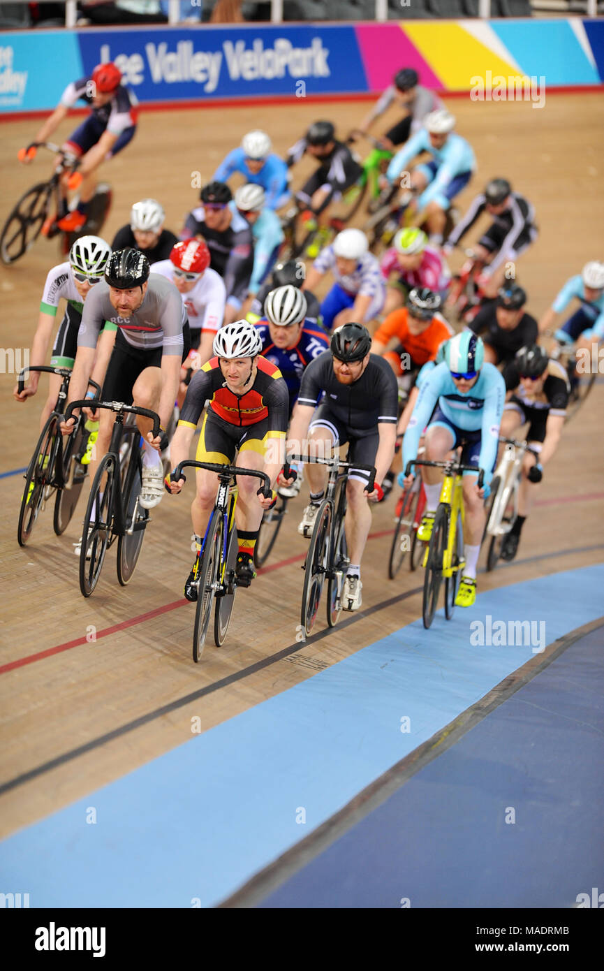 Cyclists racing in a tightly packed peleton during the Full