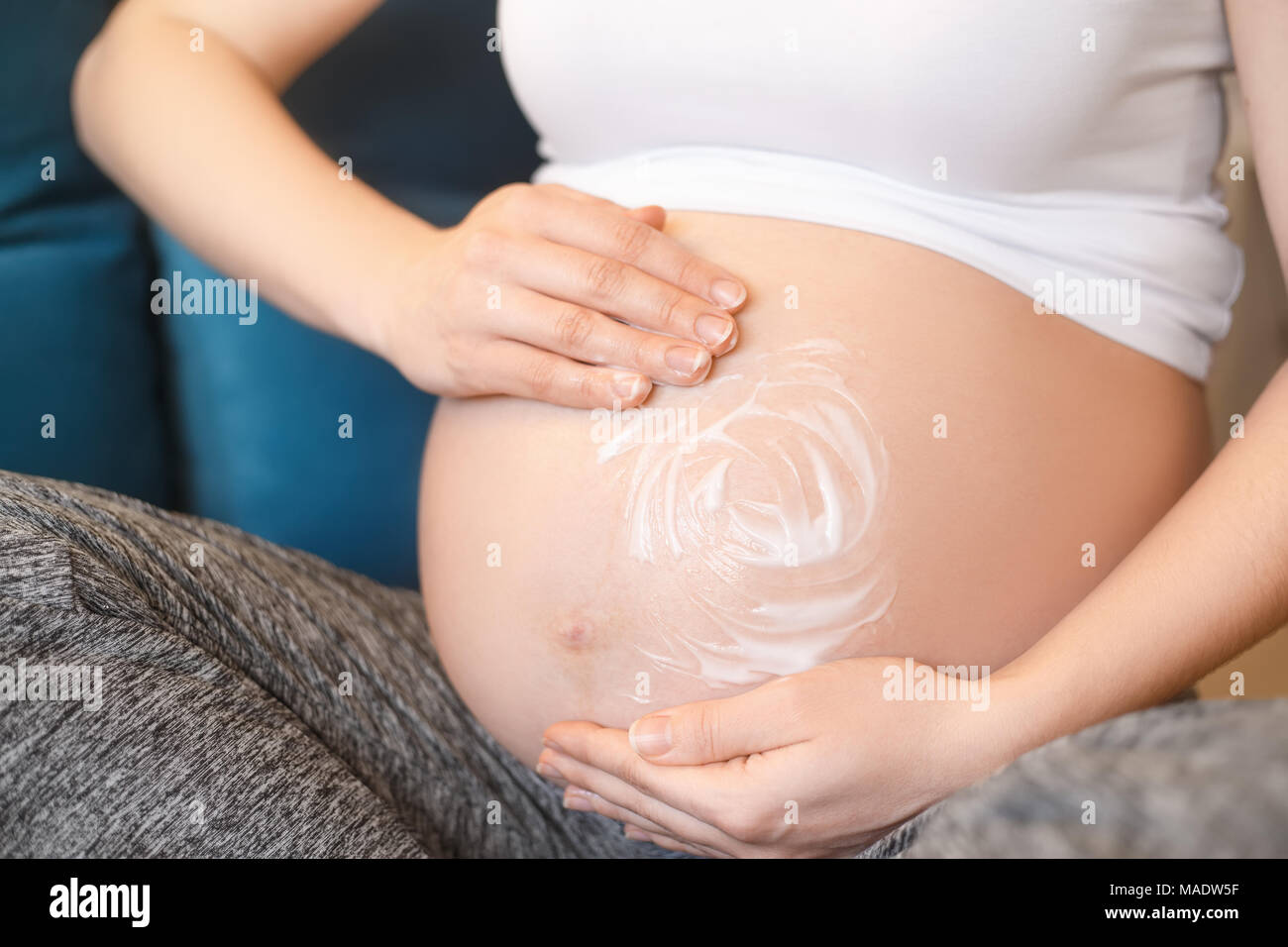 Side View Of Pregnant Belly With Peircing Stock Photo - Download