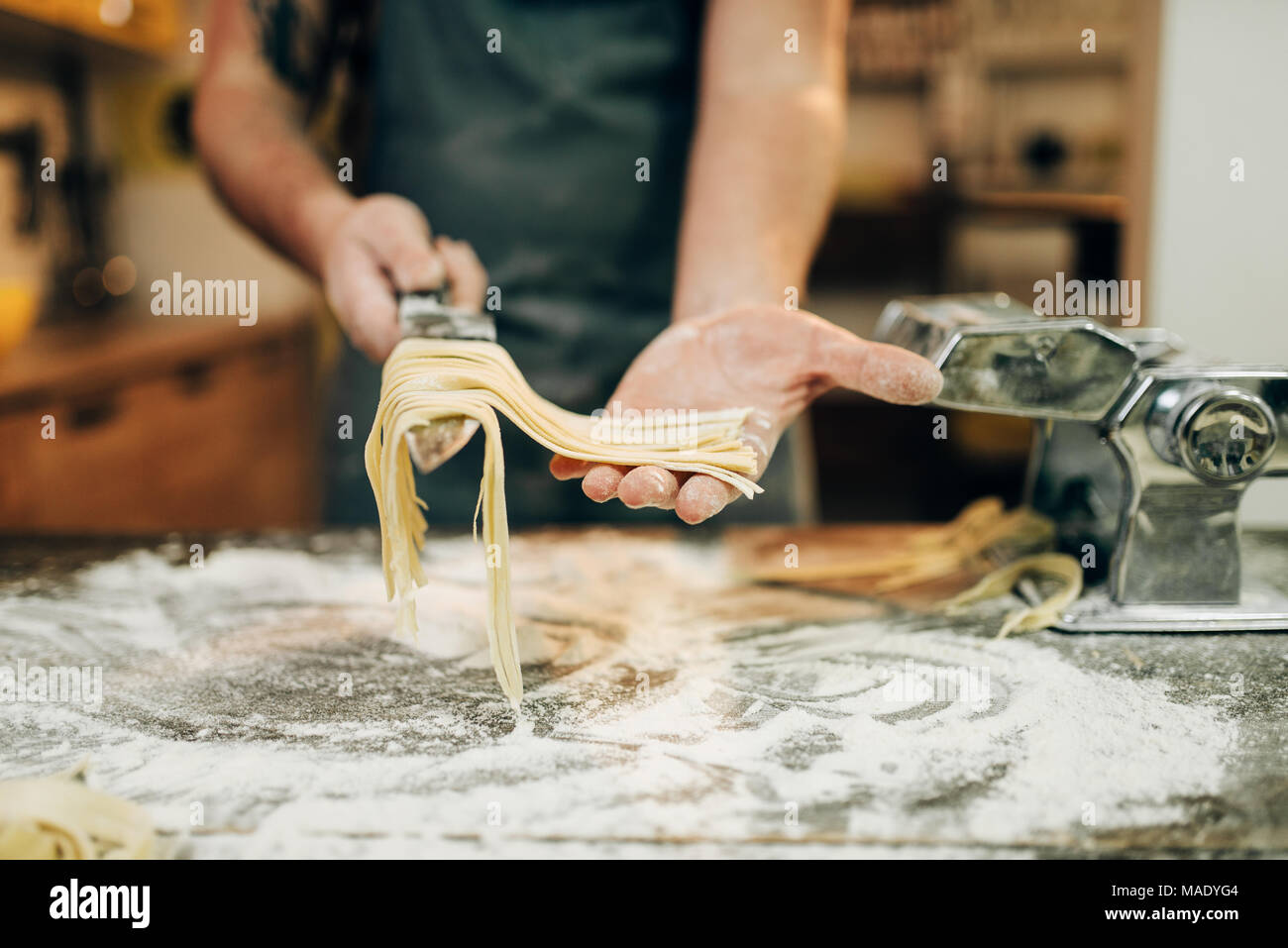 Chef cooking fettuccine in pasta machine Stock Photo Alamy