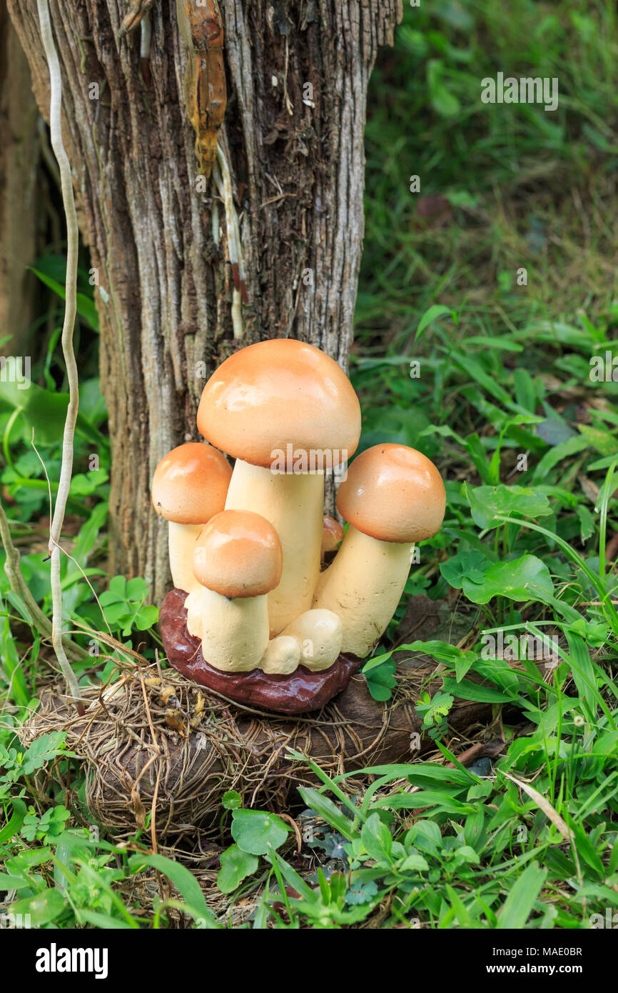 Garden decor - cement mushroom in grass Stock Photo
