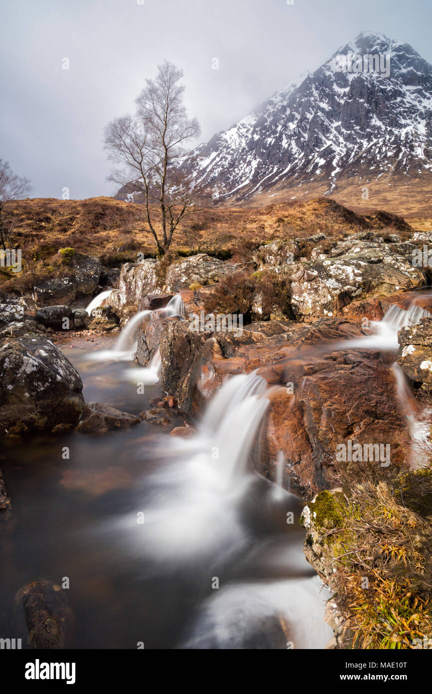 Buachaille Etive Mor and River Coupall waterfall, Glencoe, Scottish Highlands, Scotland, UK in March - long exposure Stock Photo