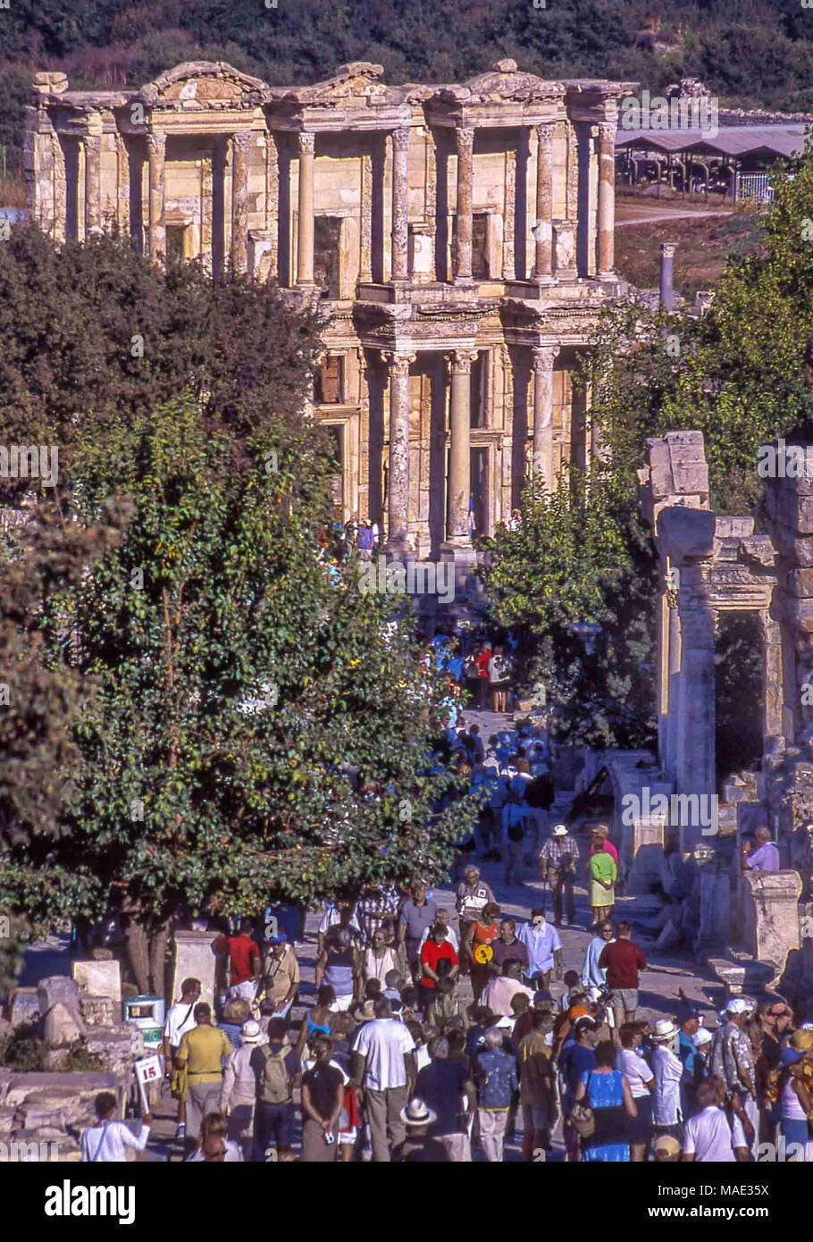 A crowd of tourists approaches the Library of Celsus in the ruins of Ephesus, a tomb for the Roman governor of the province of Asia. Built in 117 A.D. it is one of the most beautiful and most photographed structures in Ephesus. An ancient Greek city on the Ionian coast, dating to the 10th century BC, Ephesus was a religious, cultural and commercial center noted for its temples and architecture. Its ruins are now a favorite international tourist attraction and a UNESCO World Heritage Site. 9th Oct, 2004. Credit: Arnold Drapkin/ZUMA Wire/Alamy Live News Stock Photo