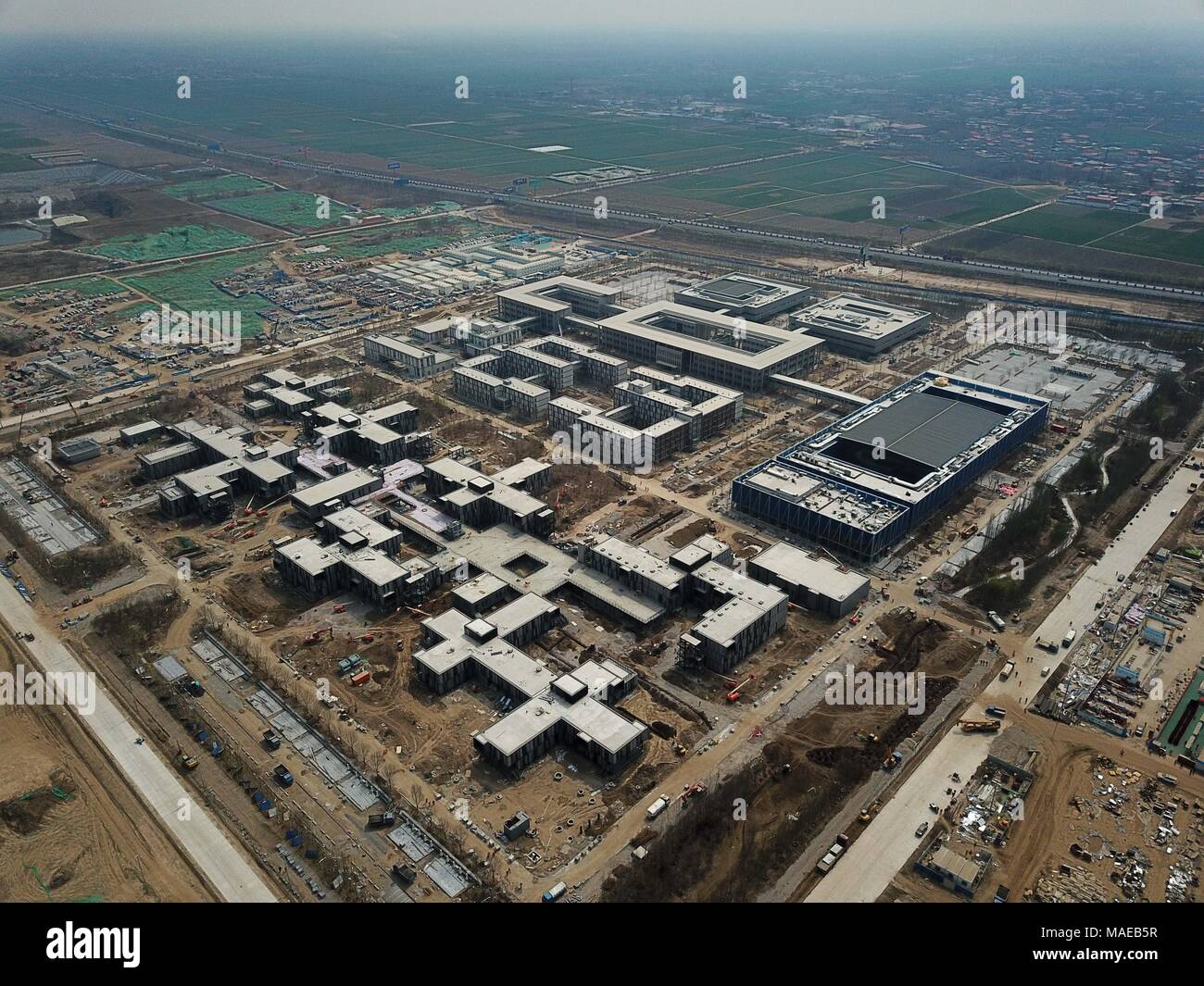 XIONGAN NEW AREA, April 1, 2018 (Xinhua) -- This aerial photo taken on March 30, 2018 shows construction site of the Xiongan public services center in Xiongan New Area, north China's Hebei Province. Xiongan New Area, established on April 1, 2017,It is the third new area of national significance after the Shenzhen Special Economic Zone and the Shanghai Pudong New Area. China aims to build it as a low-carbon, intelligent, livable and globally influential city where people and nature exist in harmony. (Xinhua/Sh Credit: Xinhua/Alamy Live News Stock Photo