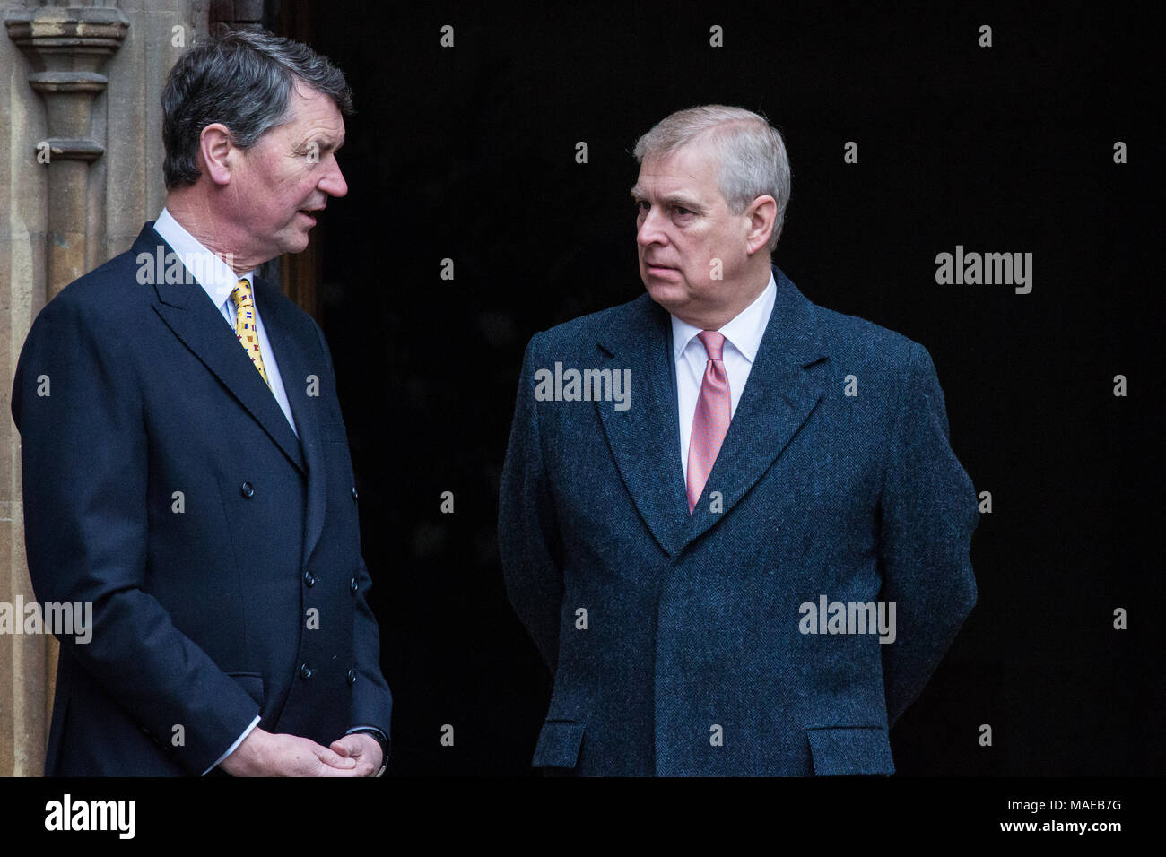 Windsor, UK. 1sat April, 2018. Prince Andrew, the Duke of York, speaks to Vice Admiral Sir Timothy Laurence outside St George's Chapel in Windsor Castle before the Easter Sunday service. Stock Photo