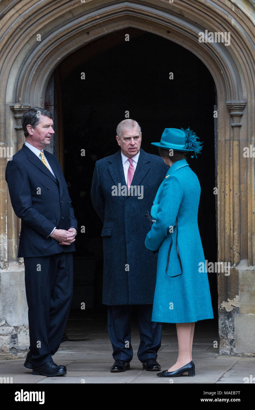 Windsor, UK. 1st April, 2018. Prince Andrew, the Duke of York, speaks to Princess Anne, the Princess Royal, and Vice Admiral Sir Timothy Laurence outside St George's Chapel in Windsor Castle before the Easter Sunday service. Credit: Mark Kerrison/Alamy Live News Stock Photo