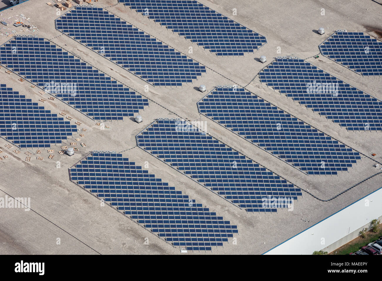 An aerial view of a rooftop commercial building with solar panels. Stock Photo