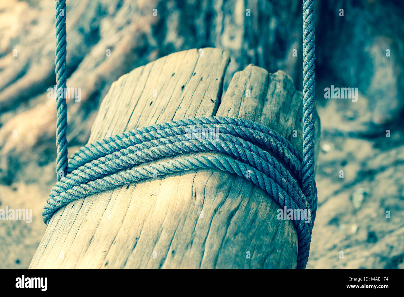 Pole with a rope tied around it, vintage style Stock Photo