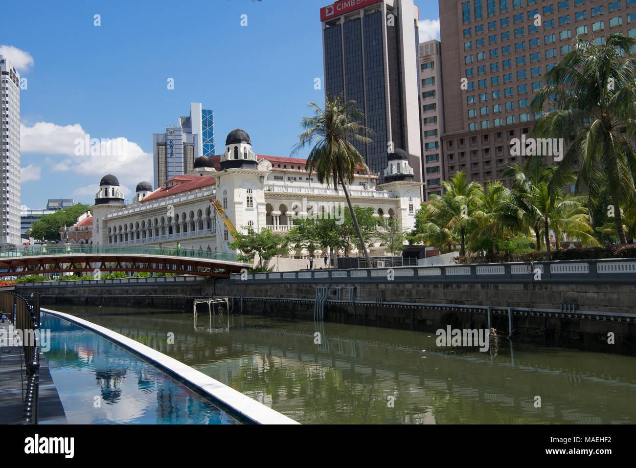 Klang River and 19th century colonial building surrounded by high rise modern buildings Kuala Lumpur Malaysia Stock Photo