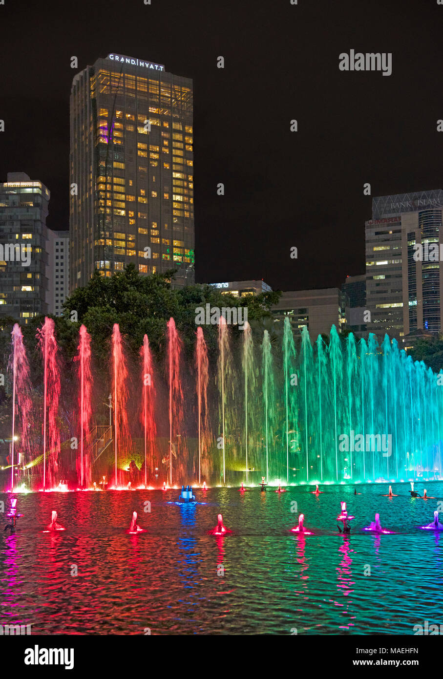 Multi coloured fountains and city skyscrapers at night  Kuala Lumpur Malaysia Stock Photo