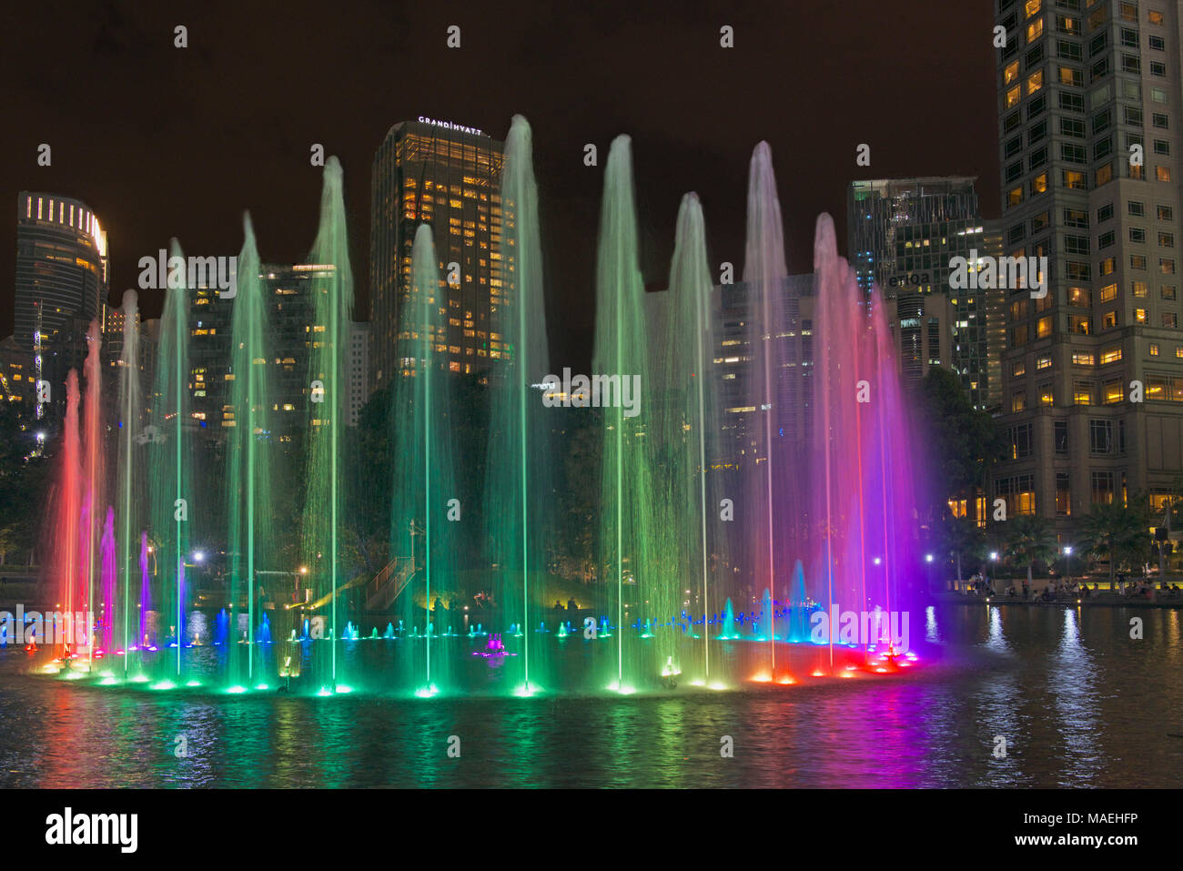 Multi coloured fountains and city skyscrapers at night  Kuala Lumpur Malaysia Stock Photo
