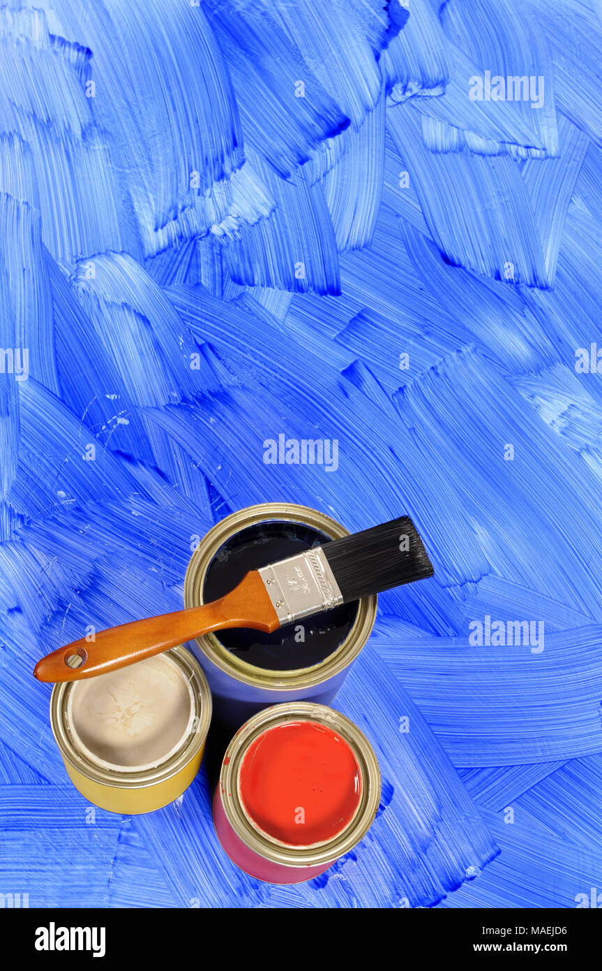 Partly finished blank blue painted floor with paint cans and paintbrush.  Space for copy. Stock Photo