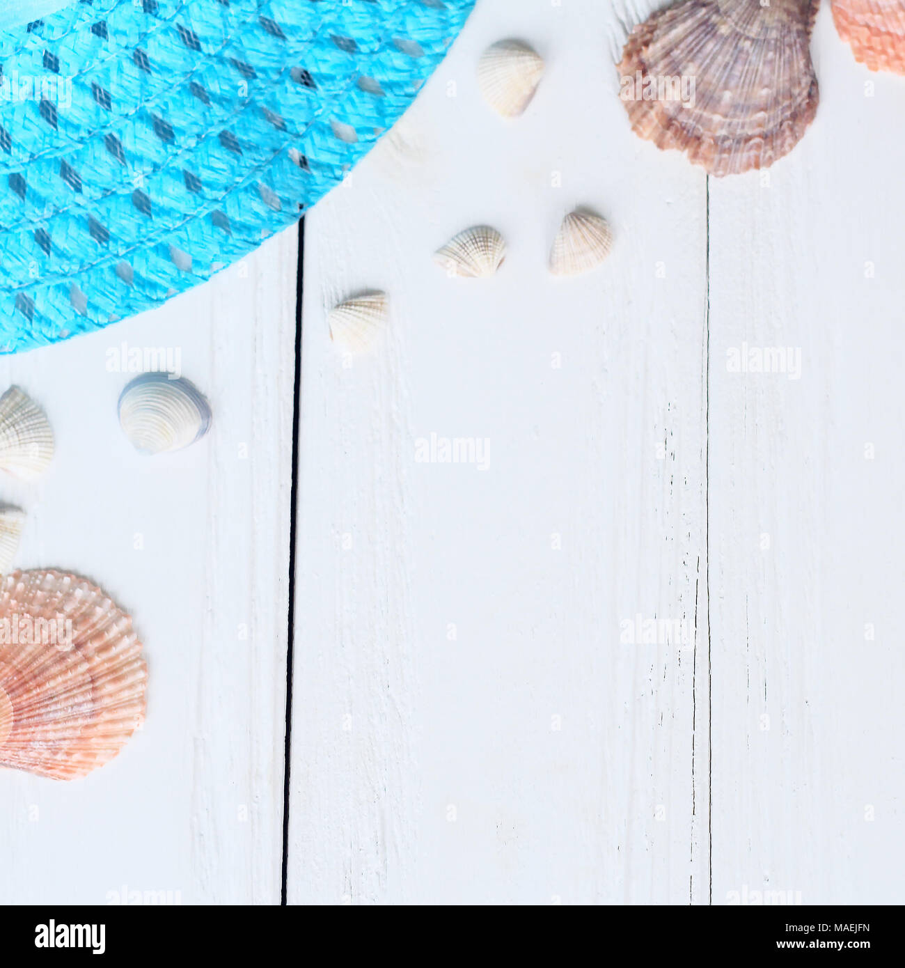 straw hat and seashells on wooden background.photo with place for text ...