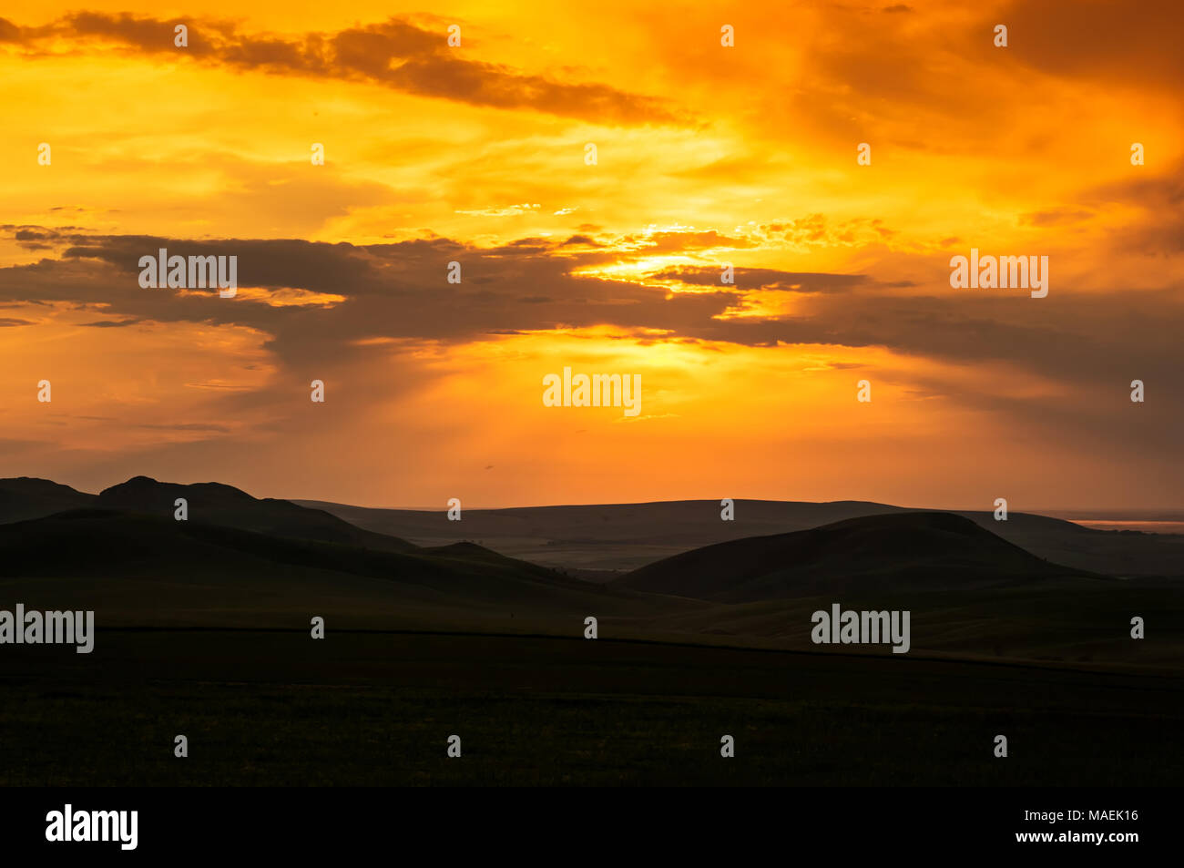 Hills and bright sky during sundown. Stock Photo