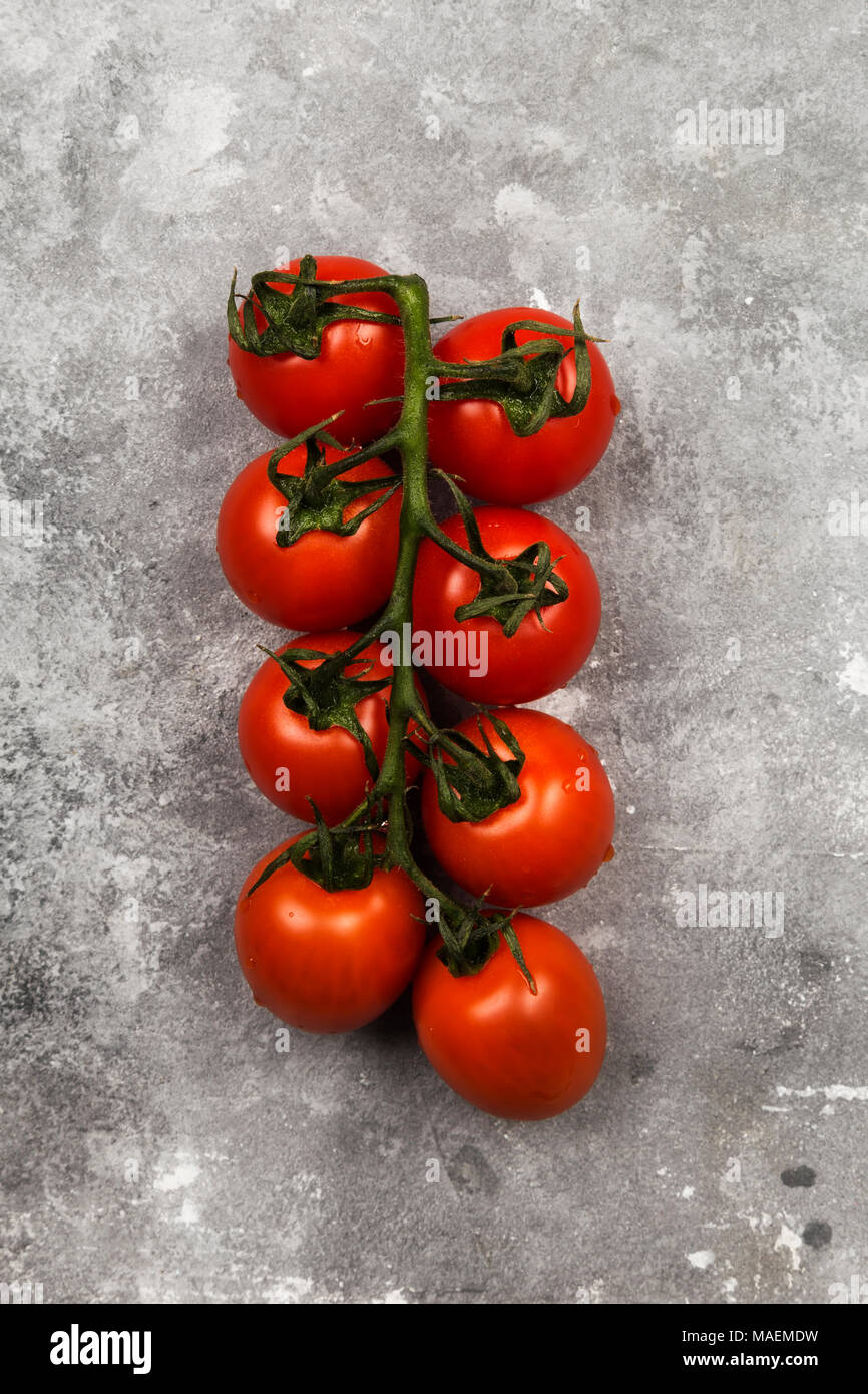 Red cherry tomatoes on gray background. Top view. Food background Stock ...