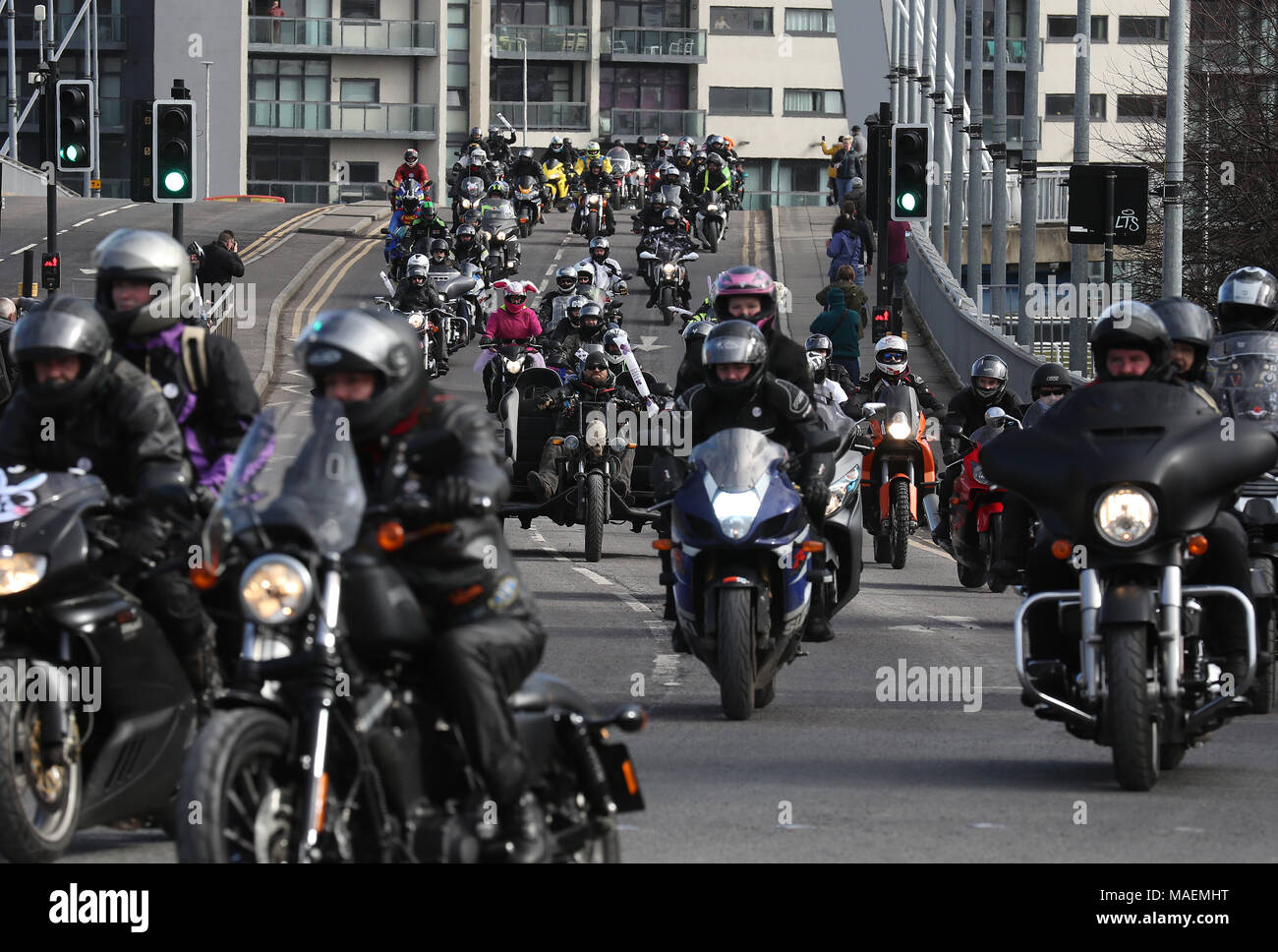 Bikers travel across the 'Squinty' Bridge in Glasgow, en route to the Queen Elizabeth University Hospital, as bikers take part in Glasgow Children's Hospital Charity Easter Egg Run on their motorbikes. Stock Photo