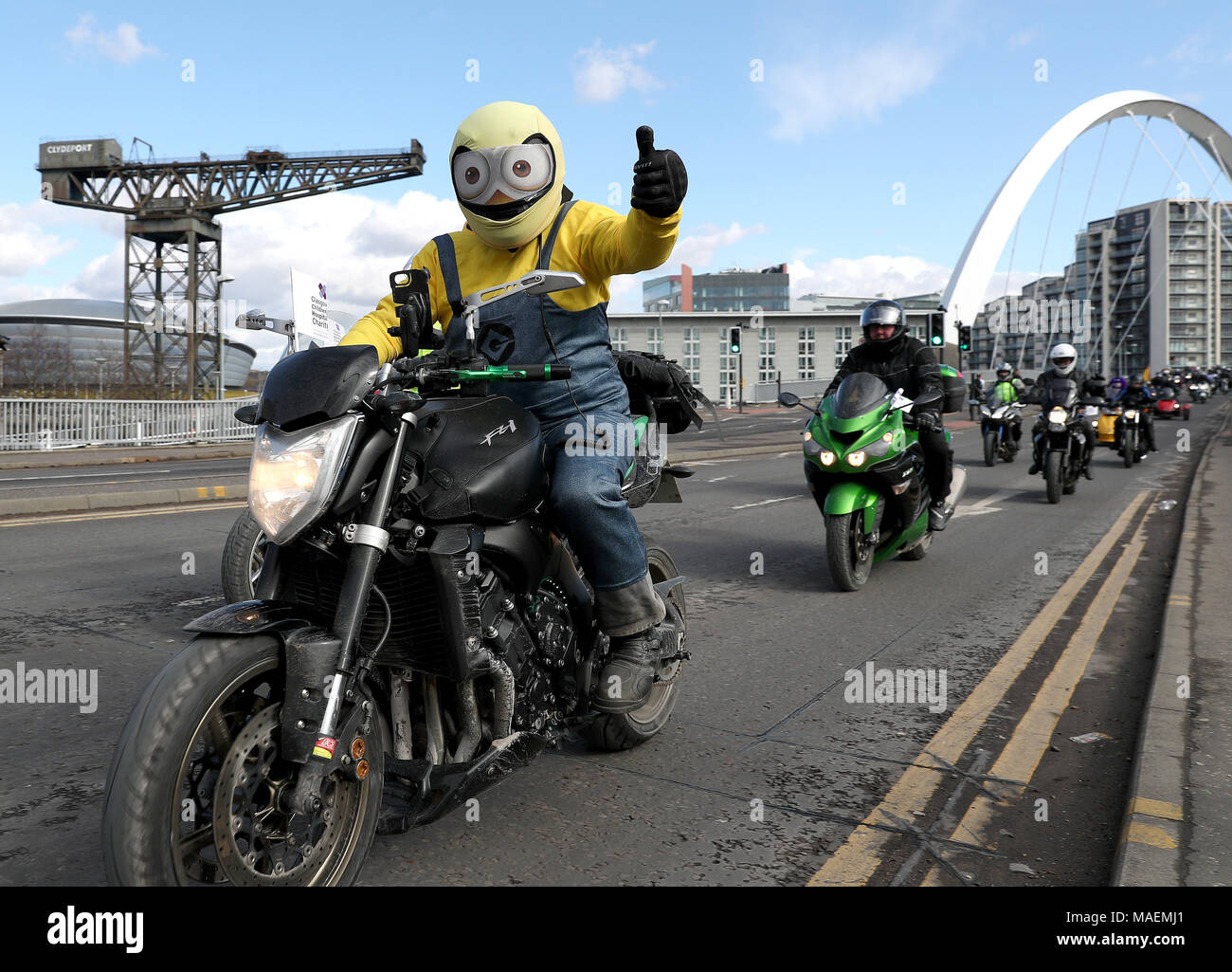 Bikers travel across the 'Squinty' Bridge in Glasgow, en route to the Queen Elizabeth University Hospital, as bikers take part in Glasgow Children's Hospital Charity Easter Egg Run on their motorbikes. Stock Photo