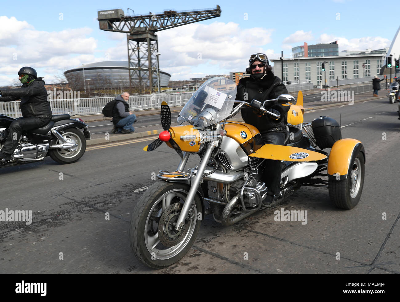 Biker Alf Grant travels across the 'Squinty' Bridge in Glasgow, en route to the Queen Elizabeth University Hospital, as bikers take part in Glasgow Children's Hospital Charity Easter Egg Run on their motorbikes. Stock Photo
