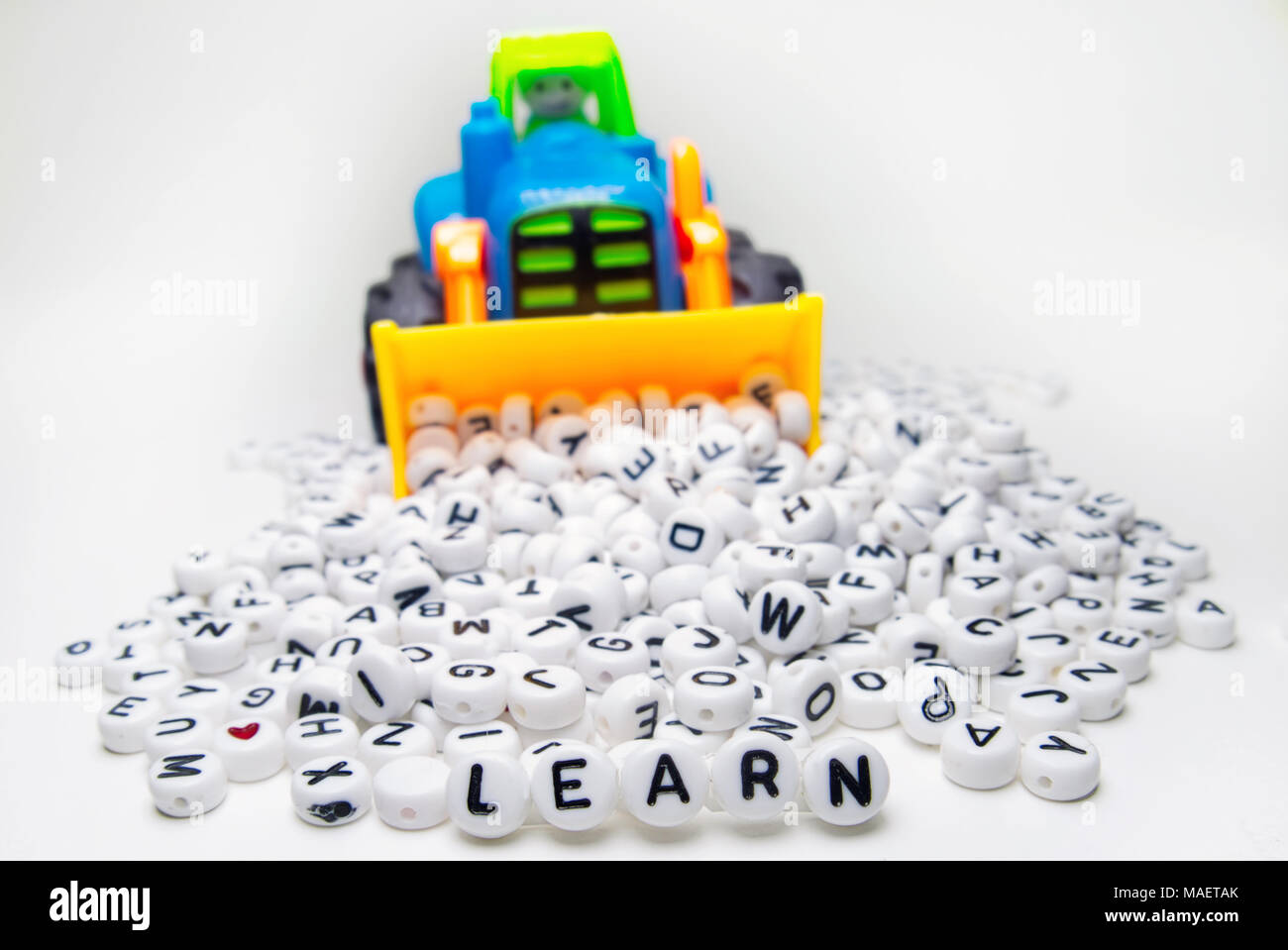 Montreal,Canada,25,March,2018.Toy tractor with small alphabet letters .Credit:Mario Beauregard/Alamy Live News Stock Photo