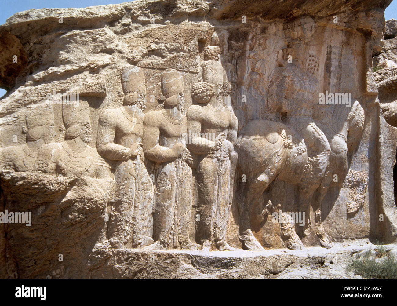 Sasanians. Relief of Shapur's Parade depicting the King Shapur I riding a horse, folllowed by his sons and other characters. 3rd century. It celebrates the king's military victory in 244 over the Roman emperor Valerian and Philip the Arab. Naqsh-e Rajab. Fars Province, Iran (Old Persia). Stock Photo