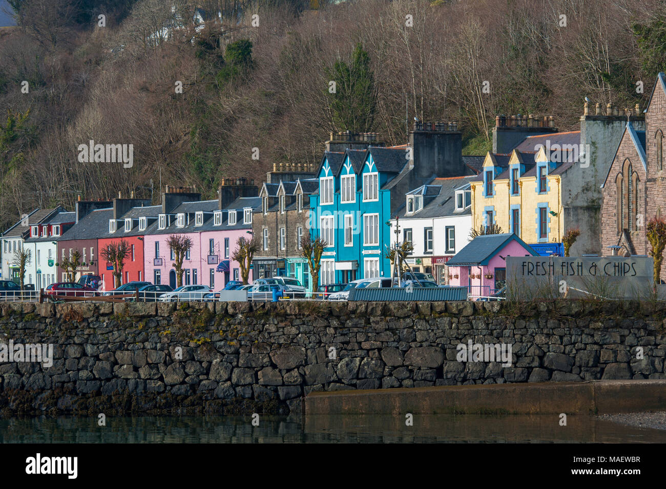 Brightly coloured shops, houses and hotels on the sea front at Tobermory on the Isle of Mull on a bright, sunny day Stock Photo