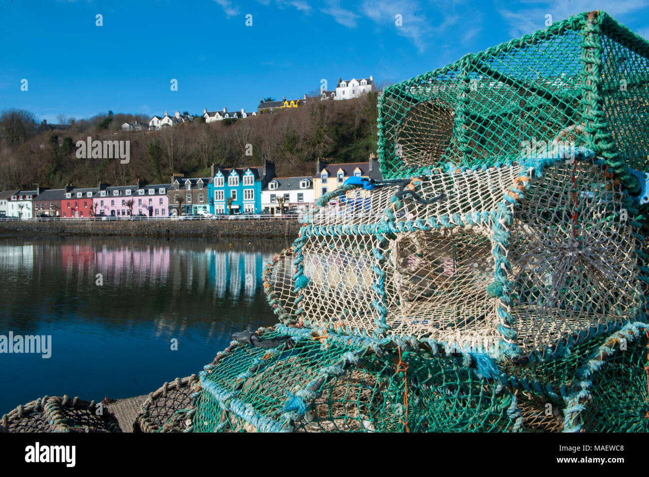 Brightly coloured shops, houses and hotels on the sea front at Tobermory on the Isle of Mull on a bright, sunny day Stock Photo