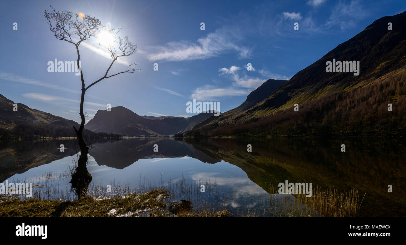 Early morning mirror-like reflections on Buttermere with Fleetwith Pike and Haystacks in the background. Stock Photo