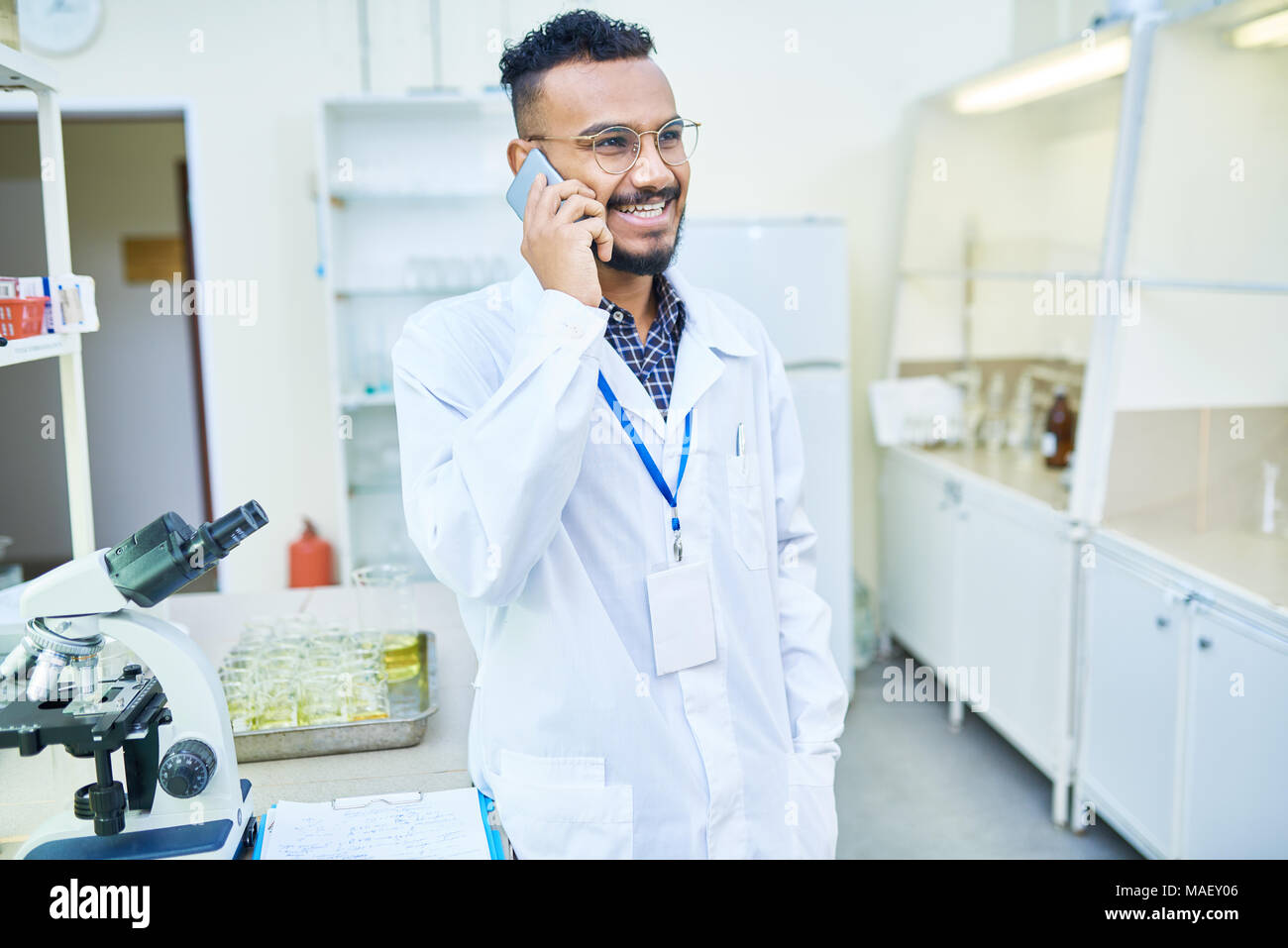 Ecstatic Arabian doctor talking on phone Stock Photo