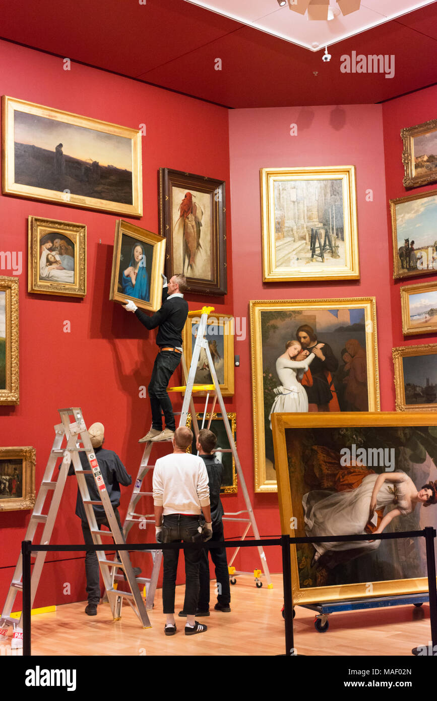 Employees change an exhibition at the National Gallery of Victoria. Stock Photo