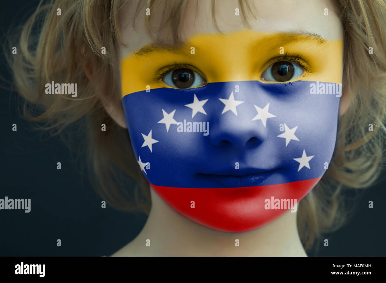 Portrait of a child with a painted Venezuelan flag Stock Photo