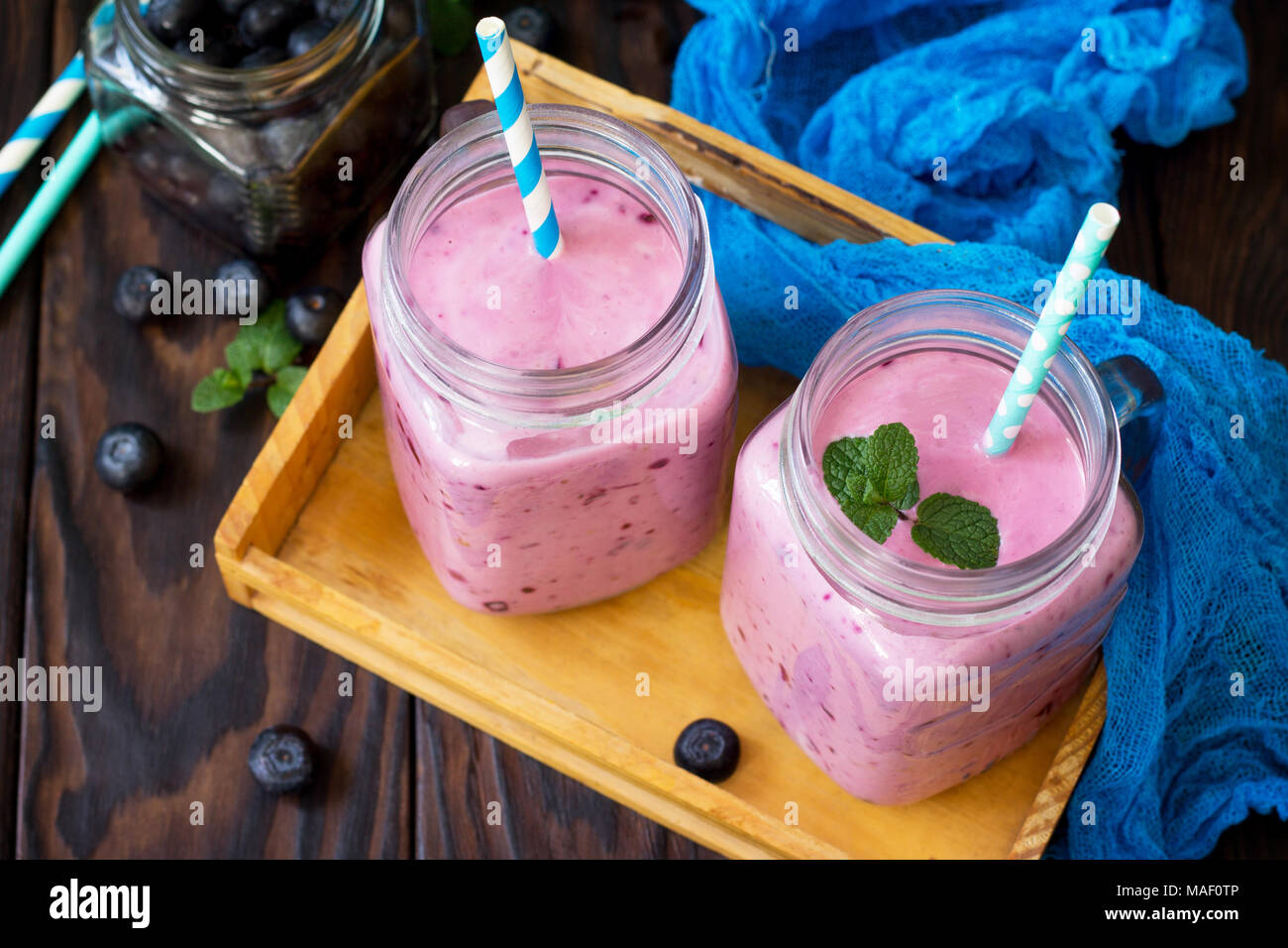 Mason jar mugs with fresh berry cocktails blueberry. Diet, concept of vegetarian food. Proper