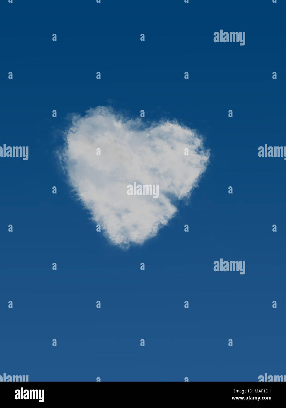 Fluffy heart cloud on sky blue. Made from real cloud elements! Stock Photo