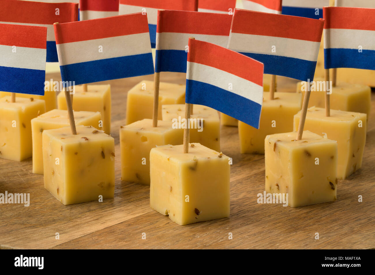 Pieces of traditional Dutch cumin cheese with a red, white and blue