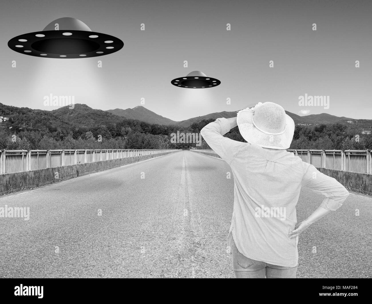 Woman watches UFOs. Vintage styling. Stock Photo