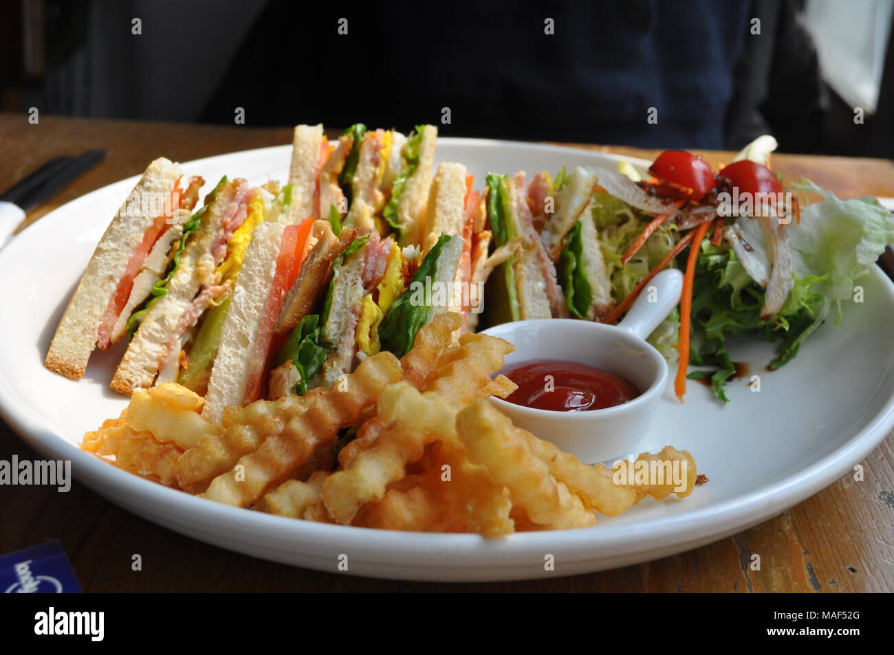 BLT Sandwich with a side of curly fries and ketchup Stock Photo