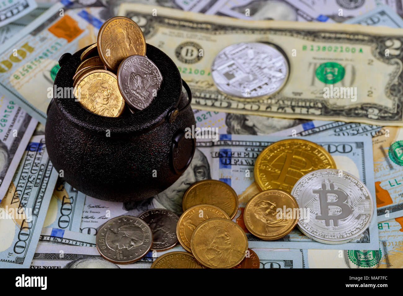 two golden coins of bitcoin and dollars and mobile phone on black  background Stock Photo - Alamy