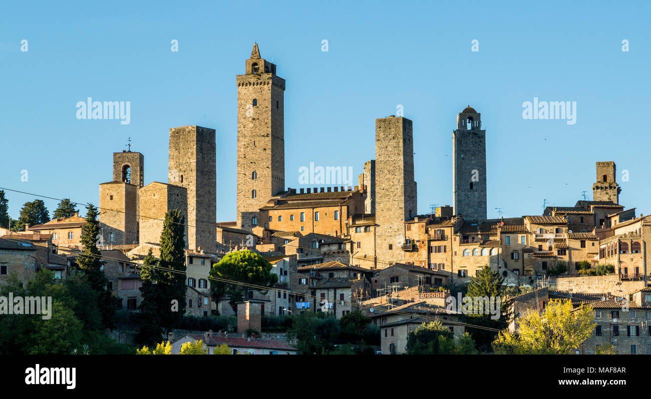 The walled hill town of San Gimignano in late afternoon sunlight Stock Photo