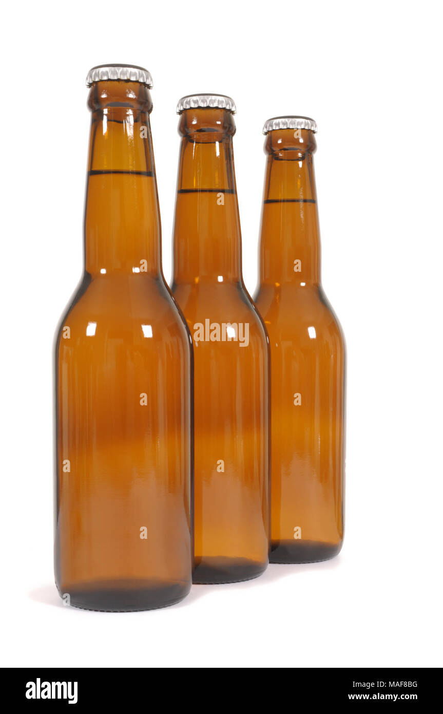 Three brown beer bottles in a row against a white background Stock