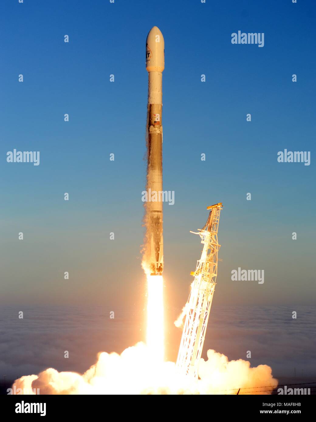 A SpaceX Falcon 9 rocket carrying the Iridium-5 satellite blasting off from Vandenberg Air Force Base March March 30, 2018 in Vandenberg, California. Stock Photo